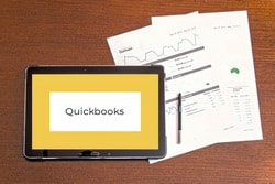 quickbooks name on tablet with two graphs